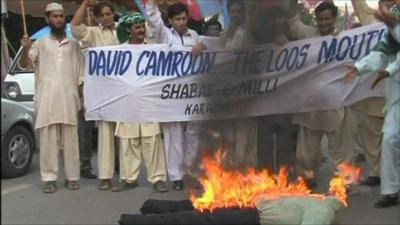 Protesters burning an effigy of David Cameron