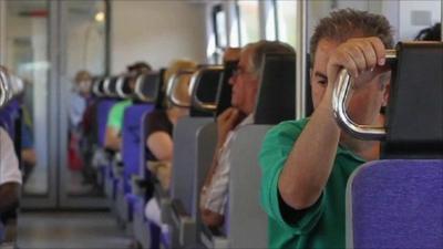 A man rides a train in Greece