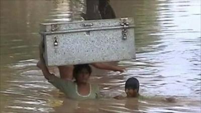 A woman and a child in flood waters