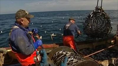 Fishermen hauling in catch on the North Sea