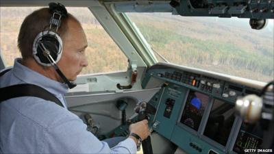 Vladimir Putin takes control of a Russian firefighting aircraft