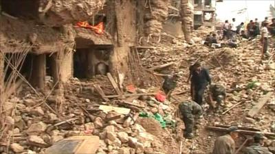 Rescue workers search through rubble