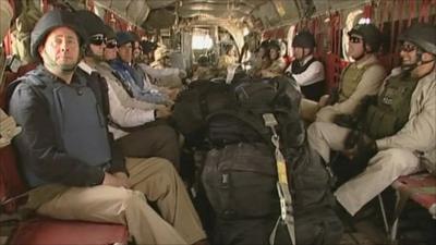 Liam Fox on plane with soldiers