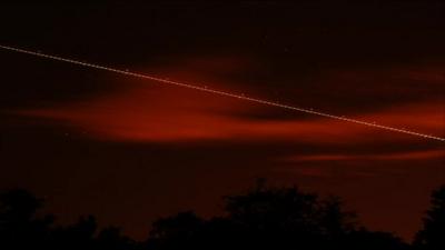 A meteor streaks across the night sky