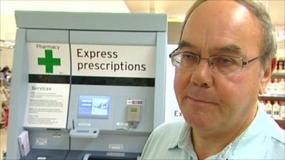 Roy Swift in front of prescription drug vending machine