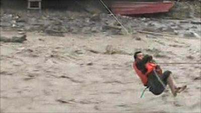 Man hanging on rope