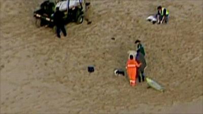 Aerial view of victim in back of vehicle on beach