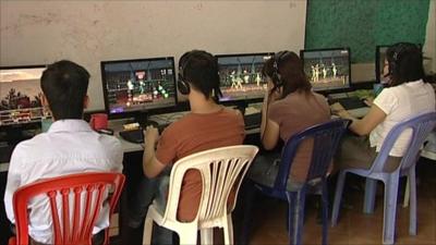 People in internet cafe