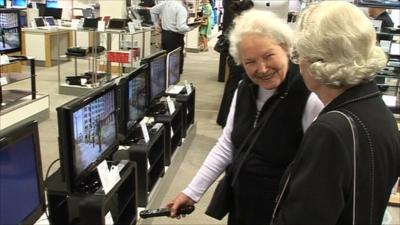 Elderly ladies loooking in TV store