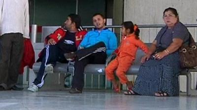 A family of Roma people waiting for their flight