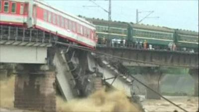 A train carriage dangling above the river