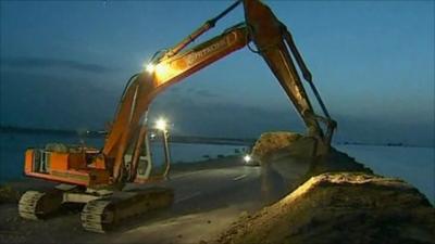 Flood defences being built by a digger