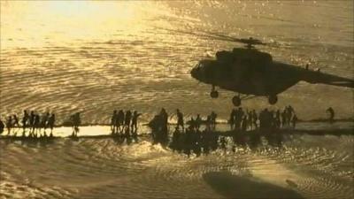 Helicopter bringing aid to people trapped by flood waters in Pakistan