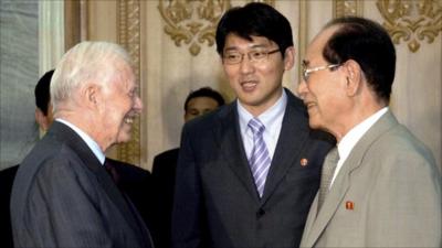 Former U.S. President Jimmy Carter (L) shakes hands with Kim Yong-nam, president of the Presidium of the Supreme People"s Assembly of North Korea