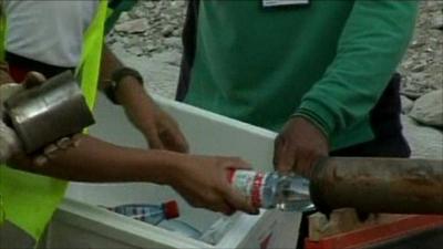 Rescue workers sending down food supplies