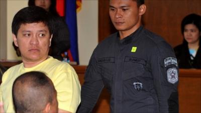 Andal Ampatuan Jnr., (L) enters a courtroom at a maximum security prison