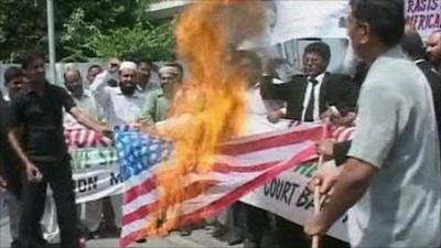 Protesters burn the American flag