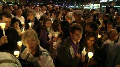 People holding candles at the vigil