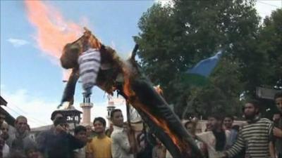 Protesters burning an effigy of President Barack Obama