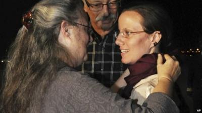 Sarah Shourd is embraced by her mother on arrival in Oman