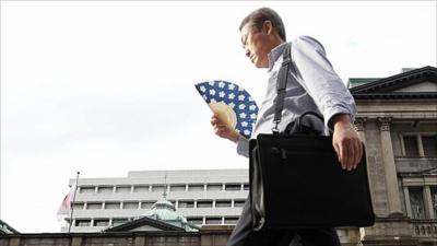 Man walks past Bank of Japan