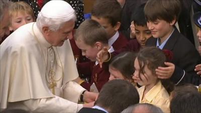 Pope being greeted by children