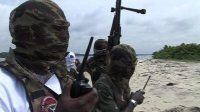 Hooded men on a beach