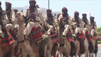 Men riding camels to mark 50 years of Mali's independence