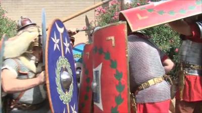 Museum staff act out a Roman battle