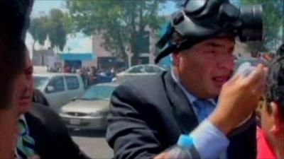 Ecuador's President Rafael Correa in a gas mask