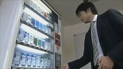 A man buys cigarettes from a vending machine