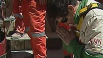 Miner Esteban Rojas prays after he is rescued