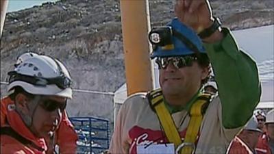 Samuel Avalos (right) raises his hand in the air