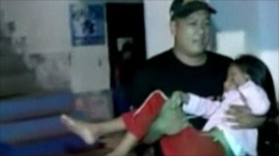 Man carries young girl