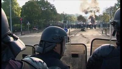 Riot police stand off in line