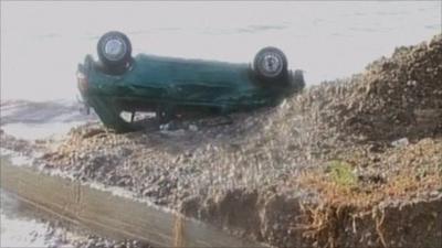 Overturned car on beach