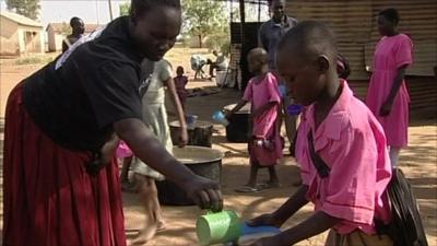 Woman giving out food to child