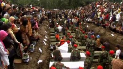 Mourners gathered at the mass grave for victims of Mount Merapi