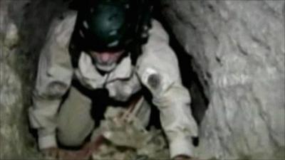 Police officer climbing in tunnel