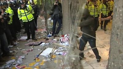 Demonstrators smashing window