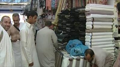 Men eye up cloth in the market