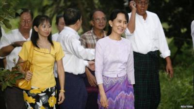 Aung San Suu Kyi walks with supporters after her release