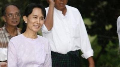 Aung San Suu Kyi walks with supporters after her release