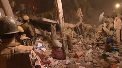 Emergency workers sort through rubble