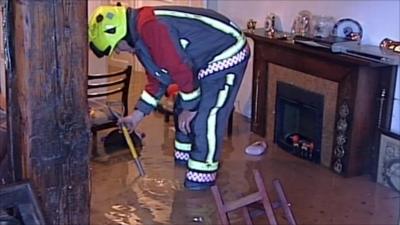 Fireman inside flooded house