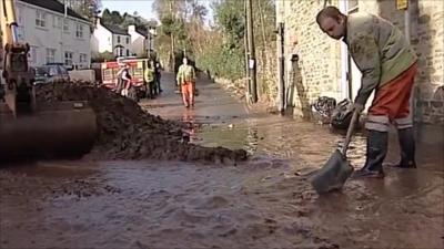 Man clearing mud and water