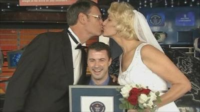 World's tallest married couple kissing