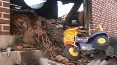 Child's tricycle in wreckage of building