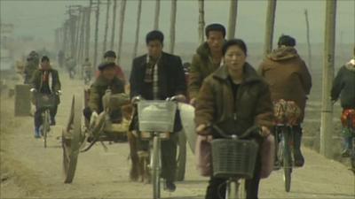 North Korean people on bicycles