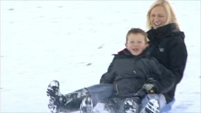 Woman and child sledging